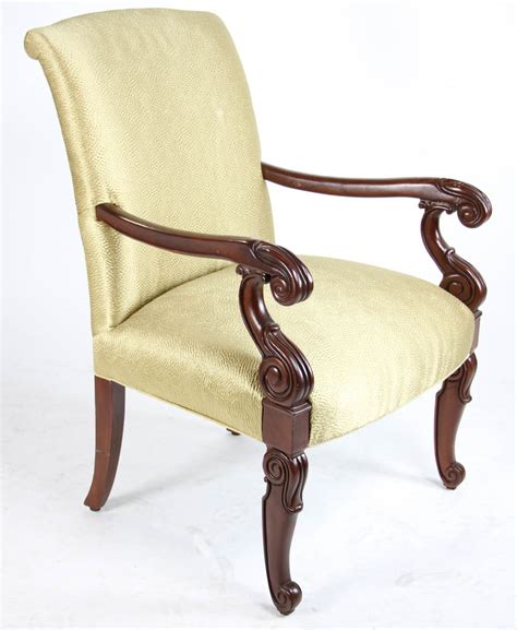 A richly coloured mahogany framed armchair with fluted legs and finely carved arms in the gillows style. Lot Detail - Carved Mahogany Armchair, Yellow Upholstery