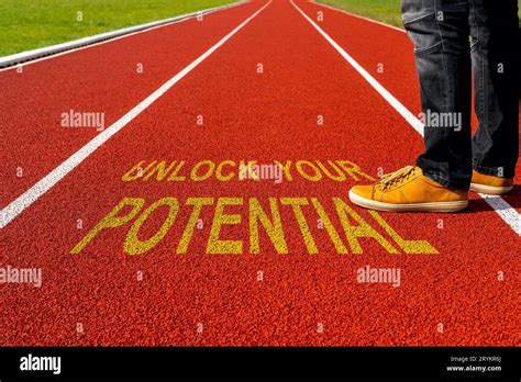 Man standing on the running track with a motivational quote written