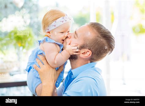 Dad Playing And Embracing His Baby Girl Stock Photo Alamy