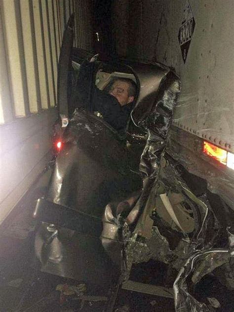 incredible photo shows man pinned between semi trucks in pileup