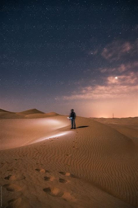 Man Walking At Night In The Desert By Mauro Grigollo Stocksy United