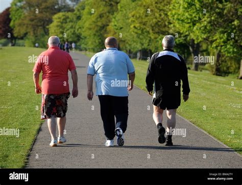 Three Fat Men Walking Through The Park Stock Photo Royalty Free Image