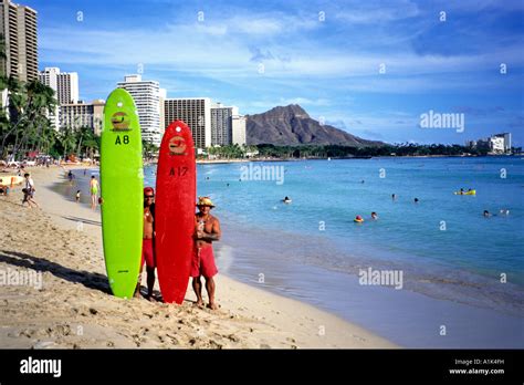 Two Longboard Surfers Pose On Waikiki Beach With Diamond Head Honolulu