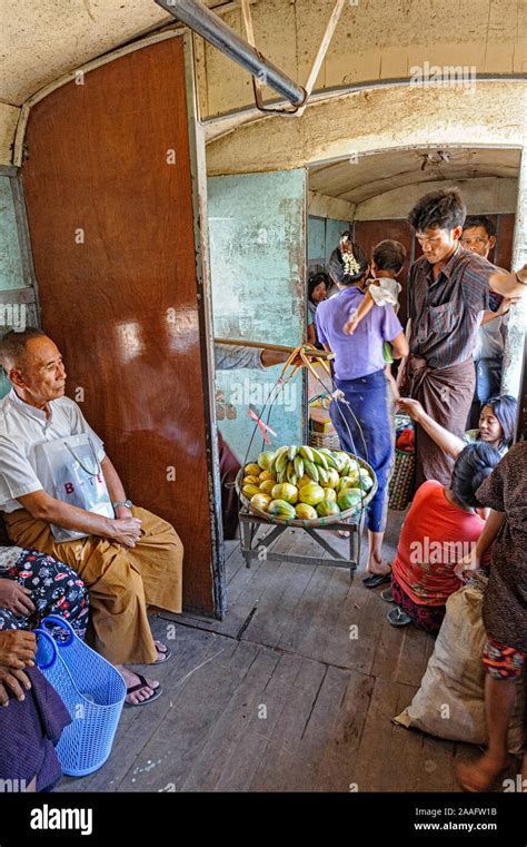 A Vendor Selling Fruit To Passengers On The Circular Train In Yangon