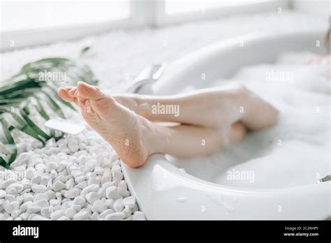 Female Person Heels Sticking Out Of The Bath With Foam Relaxation Health And Body Care In