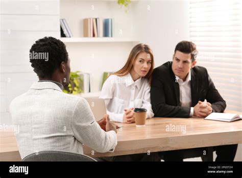 Coworkers Conducting Job Interview With African American Man In Office