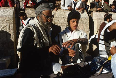 Israel Jerusalem Sephardic Rabbi Helping Boy Put On The Tefillin At His