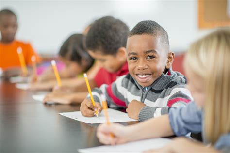 Young Boy Sitting Happily In Class Nnpa Essa Media Campaign