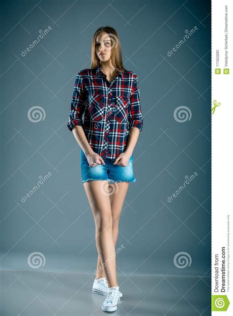 Full Length Beautiful Teen Girl In Plaid Shirt And Denim Shorts Stock