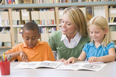 Teacher Reading To Children In Library Stock Photo Image Of Education