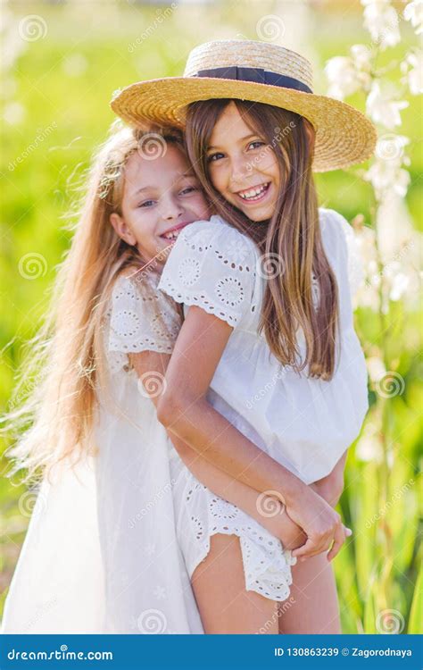 Two Girls Girlfriends Dressed In Fashion Outfits Rest Eat Ice Cream Royalty Free Stock