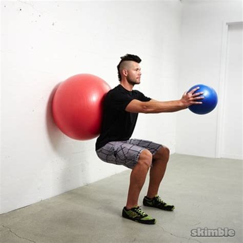 Wall Ball Squats With Ball Raises Exercise How To Skimble