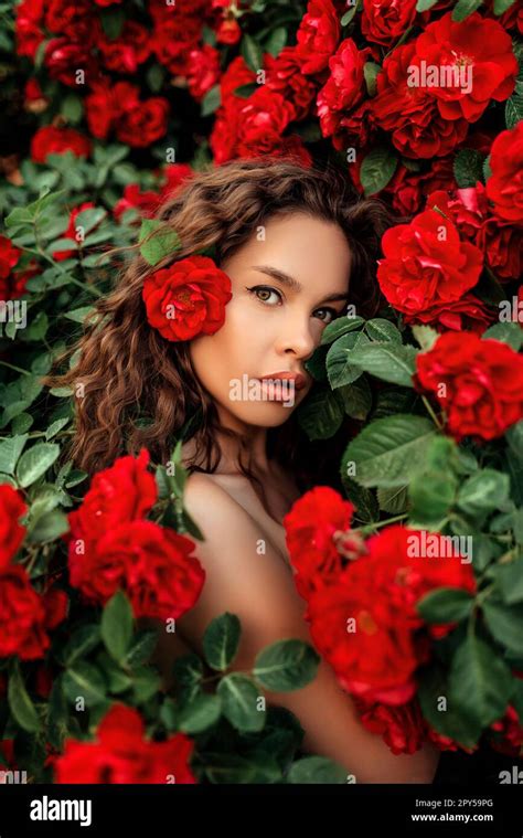 Girl In Red Dress And Straw Hat In Garden With Red Roses Gardening