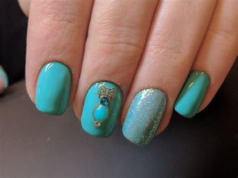 Turquoise Blue Nails With Glitter And Charmicon Blue Nail Designs