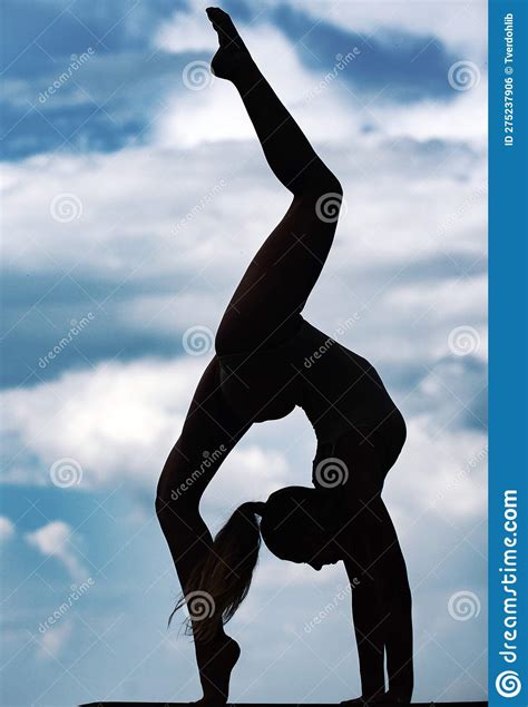 Acrobatic Gymnast Is Arching Her Back On The Beach Stock Image 37450117