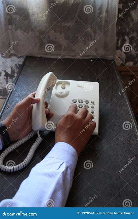 Close Up Of A Businessman`s Hand Dialing Telephone Number Stock Photo
