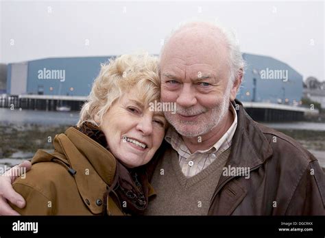 70 Year Old Couple Smiling Three Quarter Length Shot Cuddling Stock