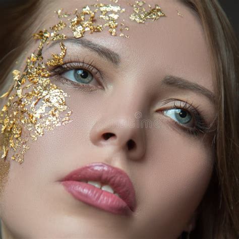 make up close up woman`s face lips eyes part golden mask cosmetics concept stock image
