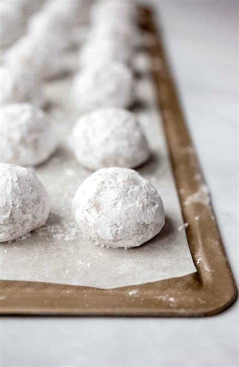 Close Up Of Snowball Cookies Rolled In Powdered Sugar Lined Up On