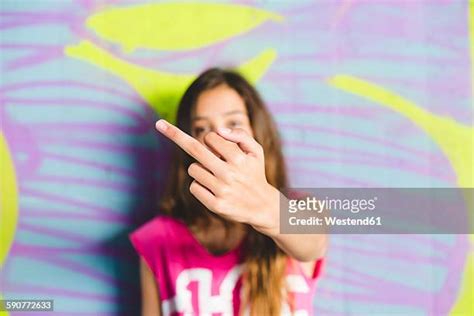 Girl Giving Middle Finger Stockfotos En Beelden Getty Images