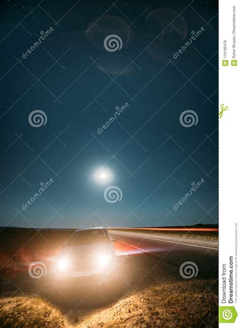 Night Starry Sky Above Country Asphalt Road In Countryside Sedan Car