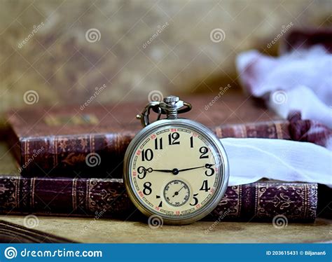 Old Pocket Watch And Books On A Table Vintage Still Stock Image