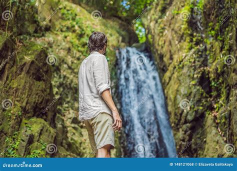 Happy Man Enjoying Amazing Tropical Waterfall Raised Hands Travel Lifestyle And Success Concept
