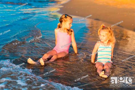 Two Adorable Kids Playing In The Sea On A Beach Stock Photo Picture