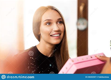 Surprised Young Woman Opens A Pink Box With A Present Stock Image Image Of Indoor