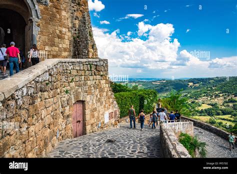Tourists Explore The Beautiful Hilltop Village Of Civita Di Bagnoregio