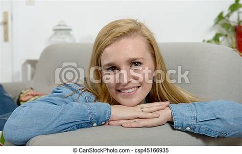 Beautiful Young Blonde Woman Relaxing On Sofa Canstock