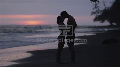 Wide Slow Motion Shot Of Couple Kissing On Beach At Sunset Youtube
