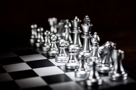 Silver Chess Pieces On A Chessboard Business Strategy Concept Stock