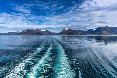 2560x1440 Resolution Ocean Near Mountain Under Blue Sky Hd Wallpaper