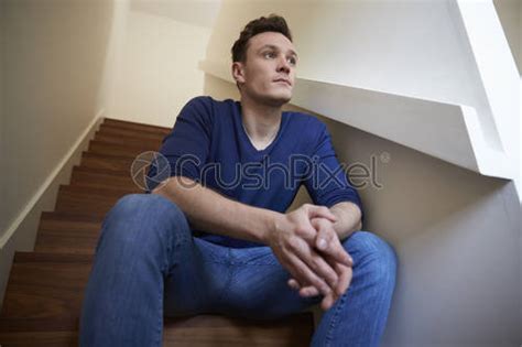 Joven Deprimido Sentado En Las Escaleras En Casa Foto De Stock 290203 Crushpixel