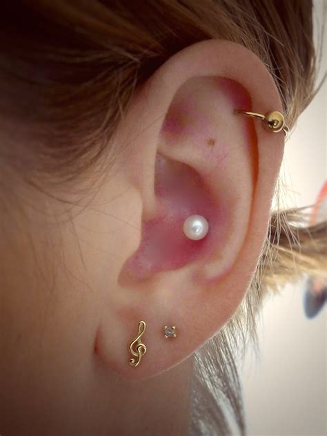 Inner Conch Piercing With Pearl Stud And Gold Jewelry Outer Conch