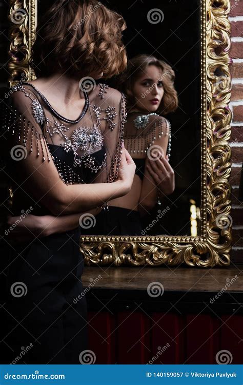 Attractive Brunette Model Wears Bra Looking To The Mirror Stock Image