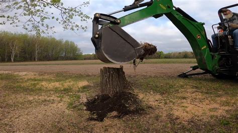 John Deere Backhoe 448 On John Deere 3320 Tractor Digging Out A Stump