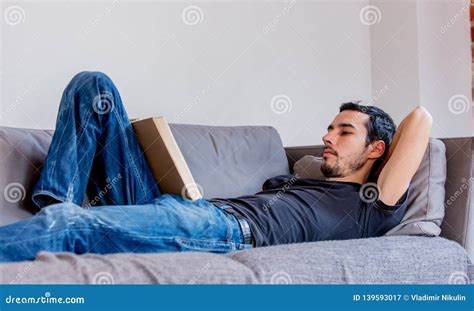 Real Man Lying Down On Sofa And Reading A Book Stock Image Image Of Casual Domestic