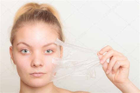 Girl Removing Facial Peel Off Mask — Stock Photo © Voyagerix 89575670