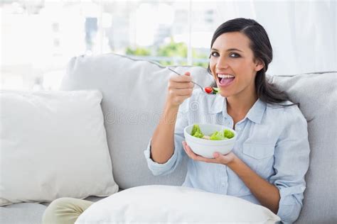 Cheerful Woman Relaxing On The Sofa Eating Salad Stock Image Image Of
