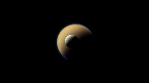 Saturns Largest And Second Largest Moons Titan And Rhea Appear To Be