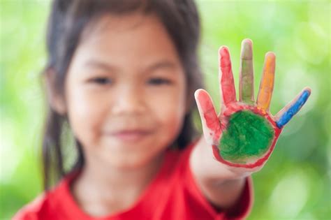 Premium Photo Cute Asian Little Child Girl With Painted Hands Showing