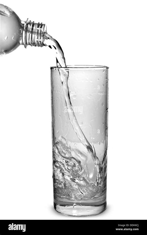 Water Pouring Into Glass From Bottle Isolated On White Stock Photo Alamy