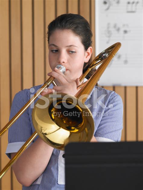 Girl Playing Trombone In Music Class Stock Photo Royalty Free