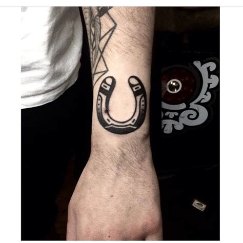 Traditional Black Horseshoe Tattoo Inked On The Outer Side Of The Left