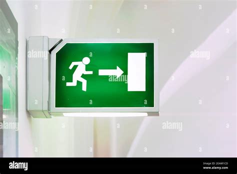 Illuminated Green Emergency Exit Sign Stock Photo Alamy