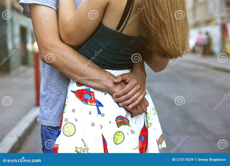 Guy Hugs Girl Focus On From Behind His Back In Her Arms Stock Image