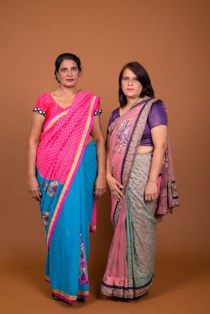 Premium Photo Two Mature Indian Women Wearing Sari Indian Traditional Clothes Together