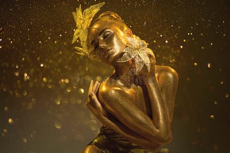Gold Woman Beauty Fashion Model Girl With Golden Make Up Long Hair On Black Background Stock